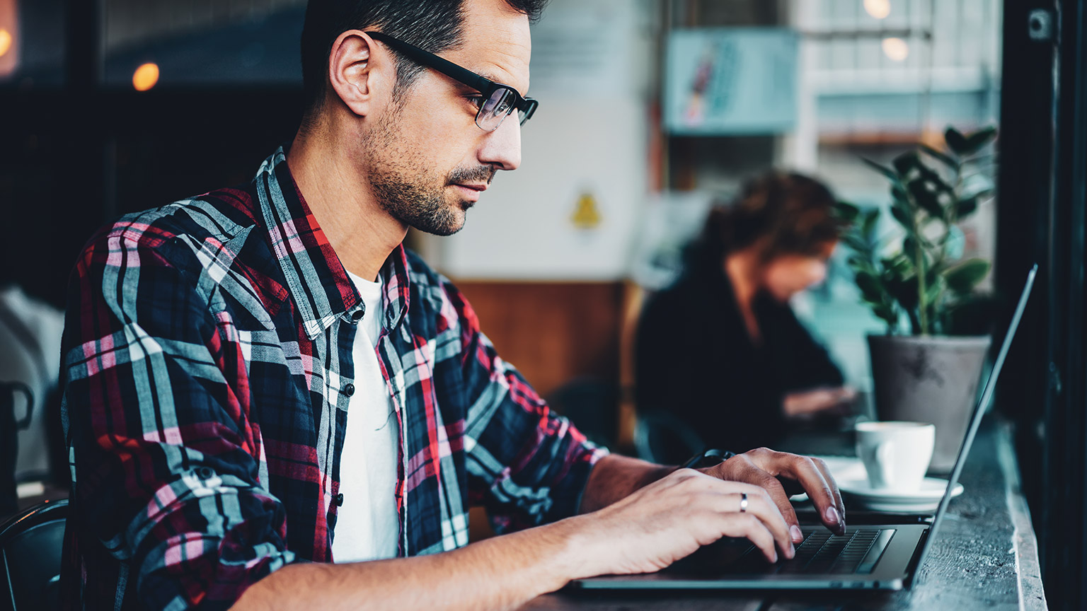 A designer working a UX project on a laptop