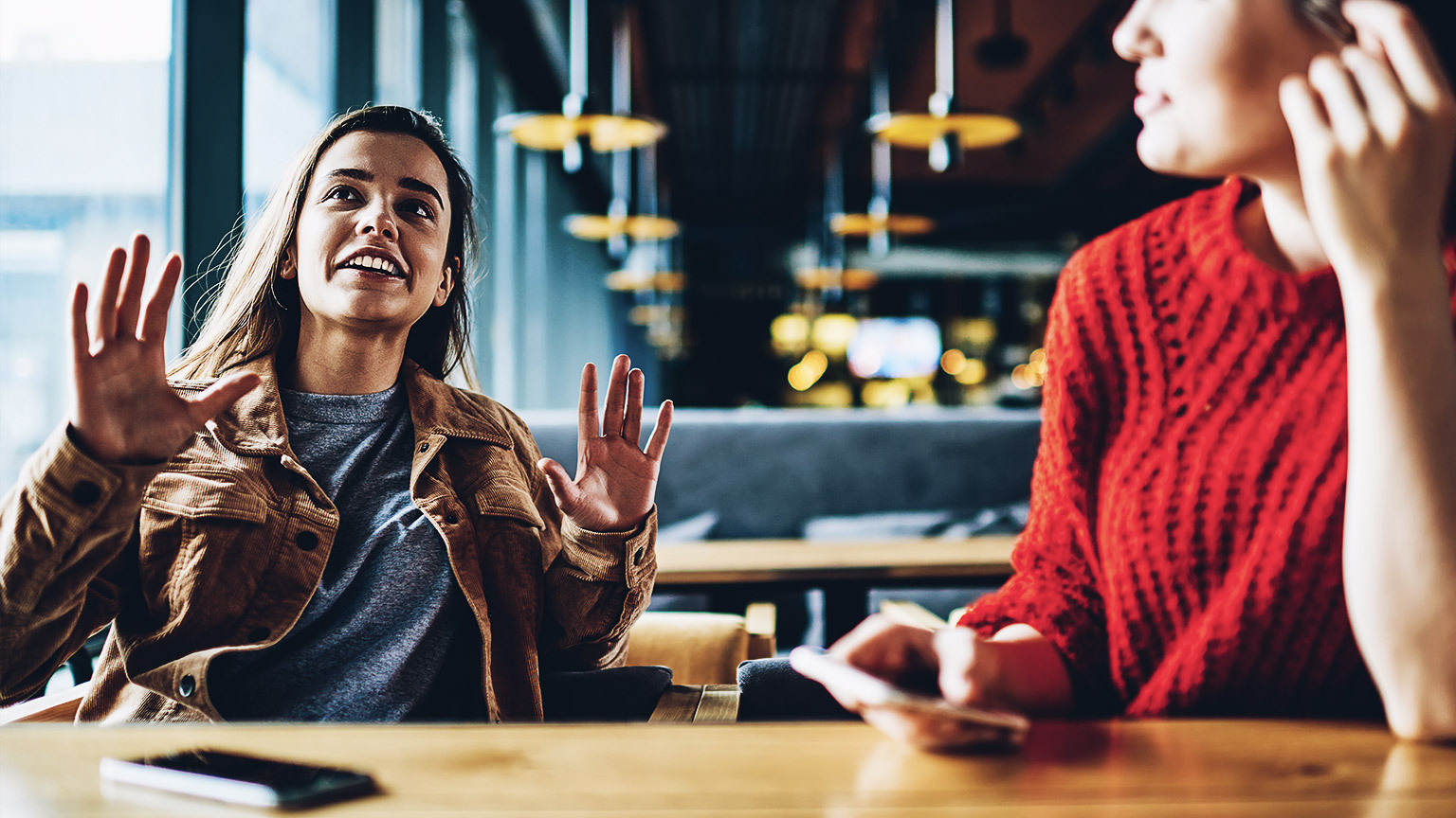 Two people conversing happily and animated