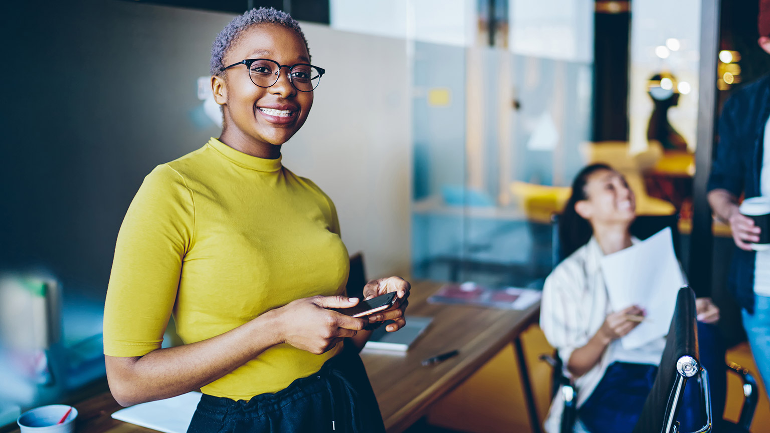 A smiling entrepreneur in a modern office space