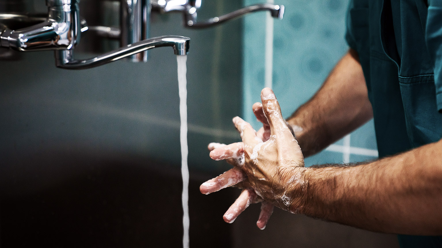 A personnel making sure hands are clean before working