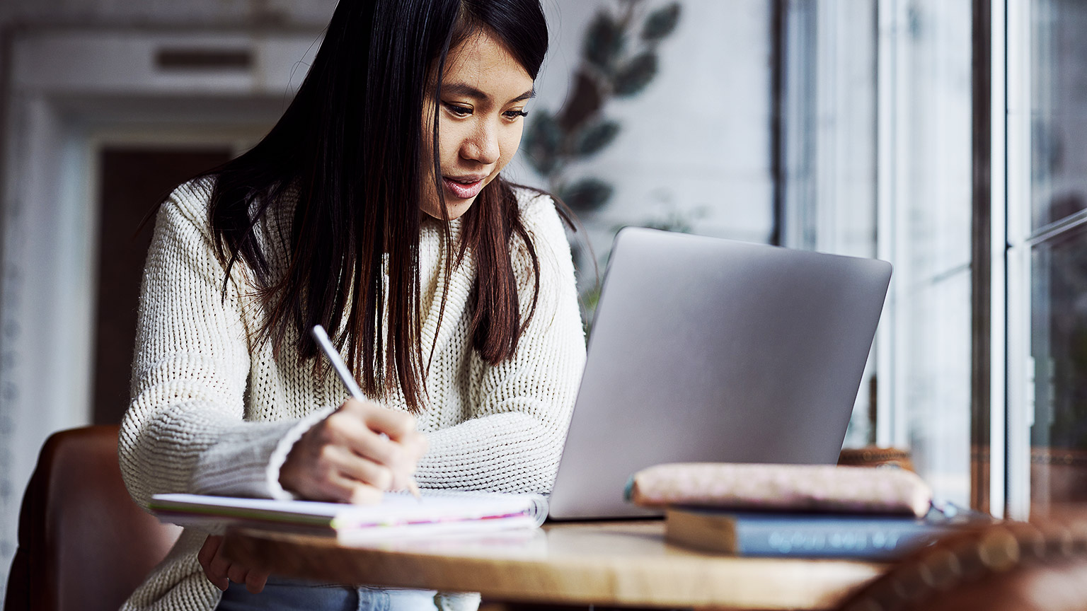 A student seated at their desk, absorbing learning materials.