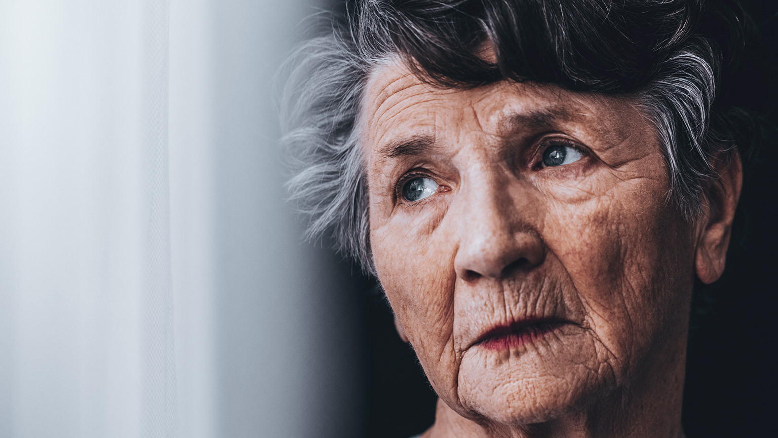 A close shot of an elderly person with a concerned look on their face