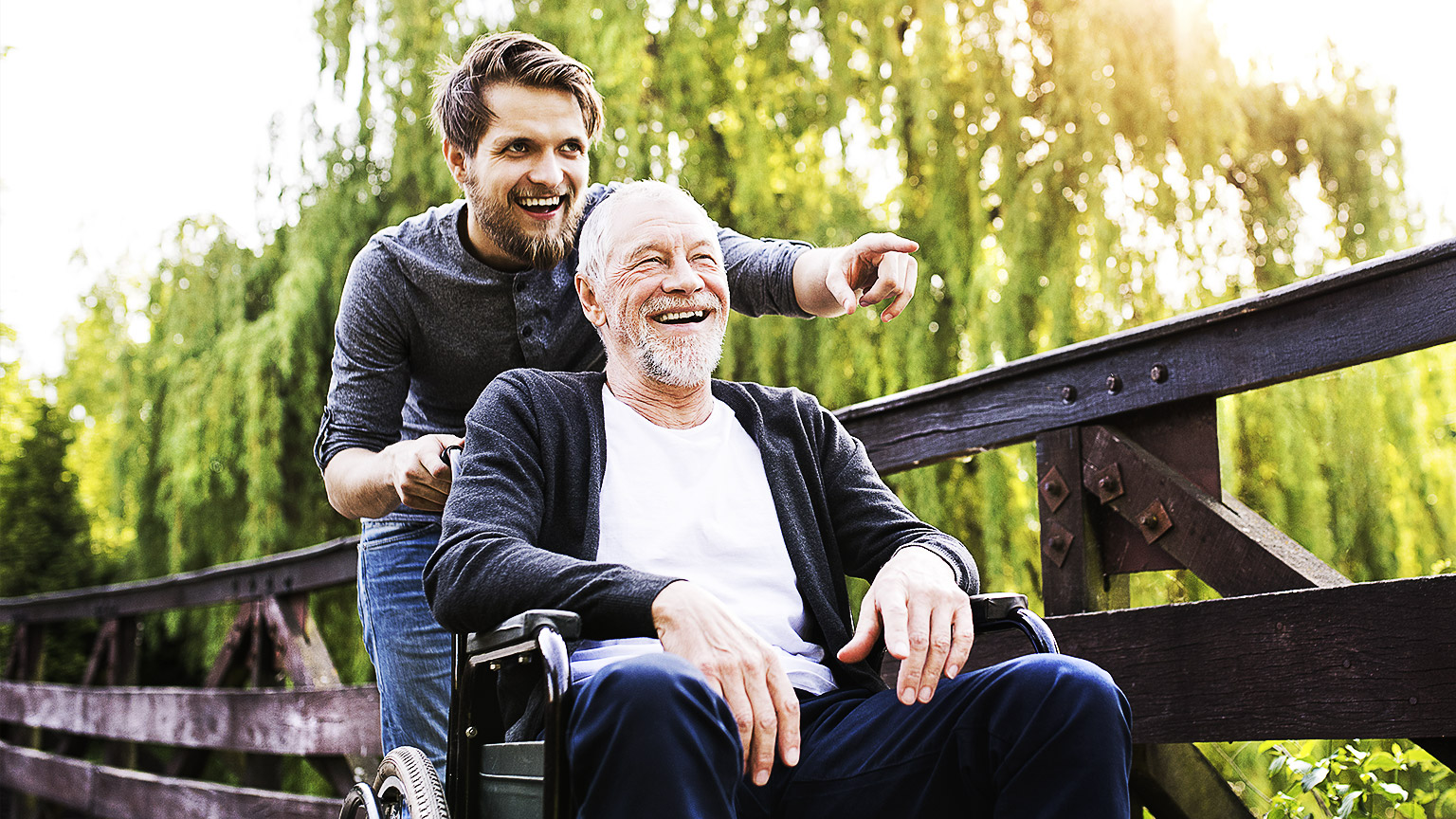 A carer and client happily interacting with each other, while out on a nature walk