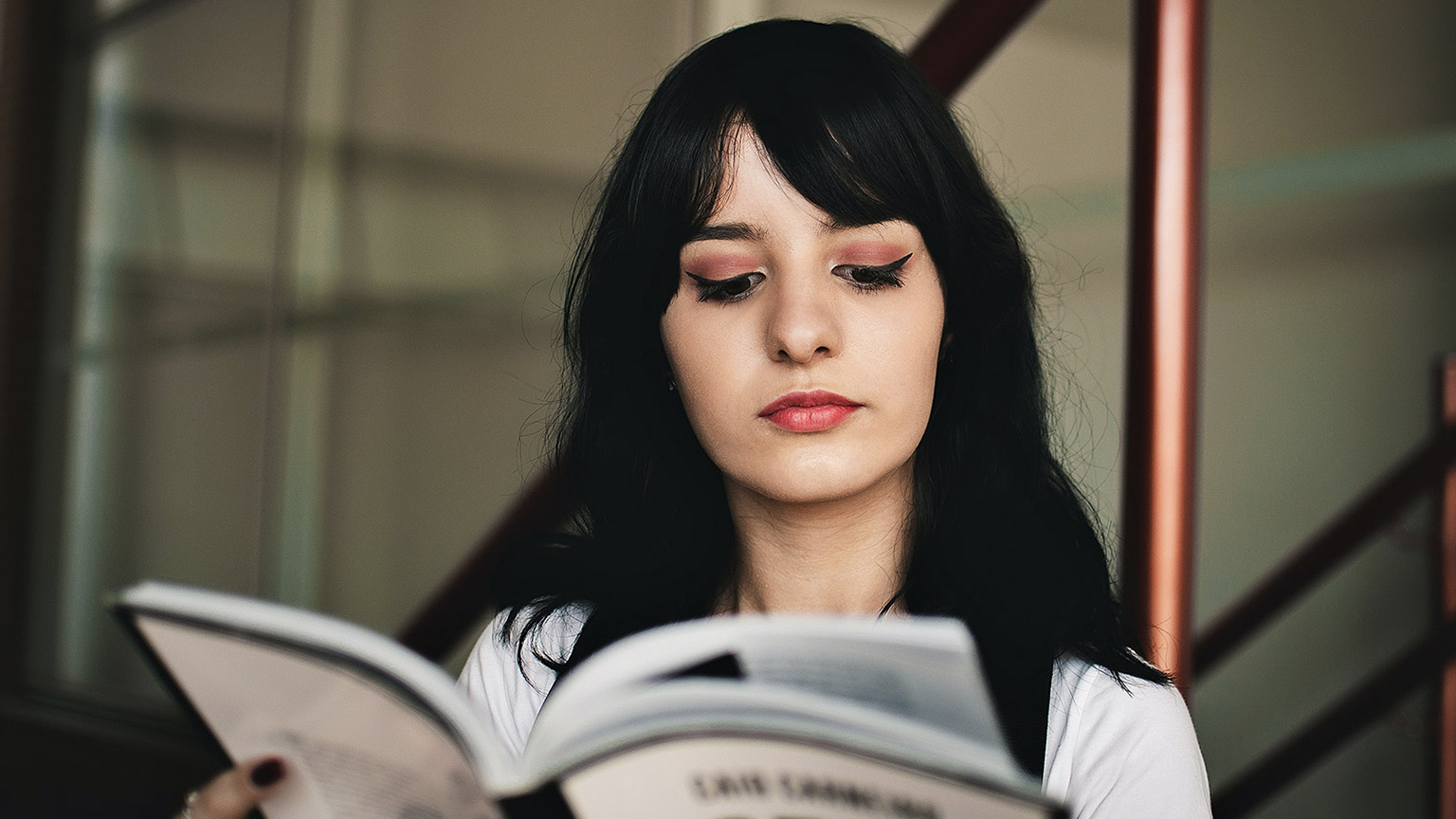 A person reading a book in an indoor environment