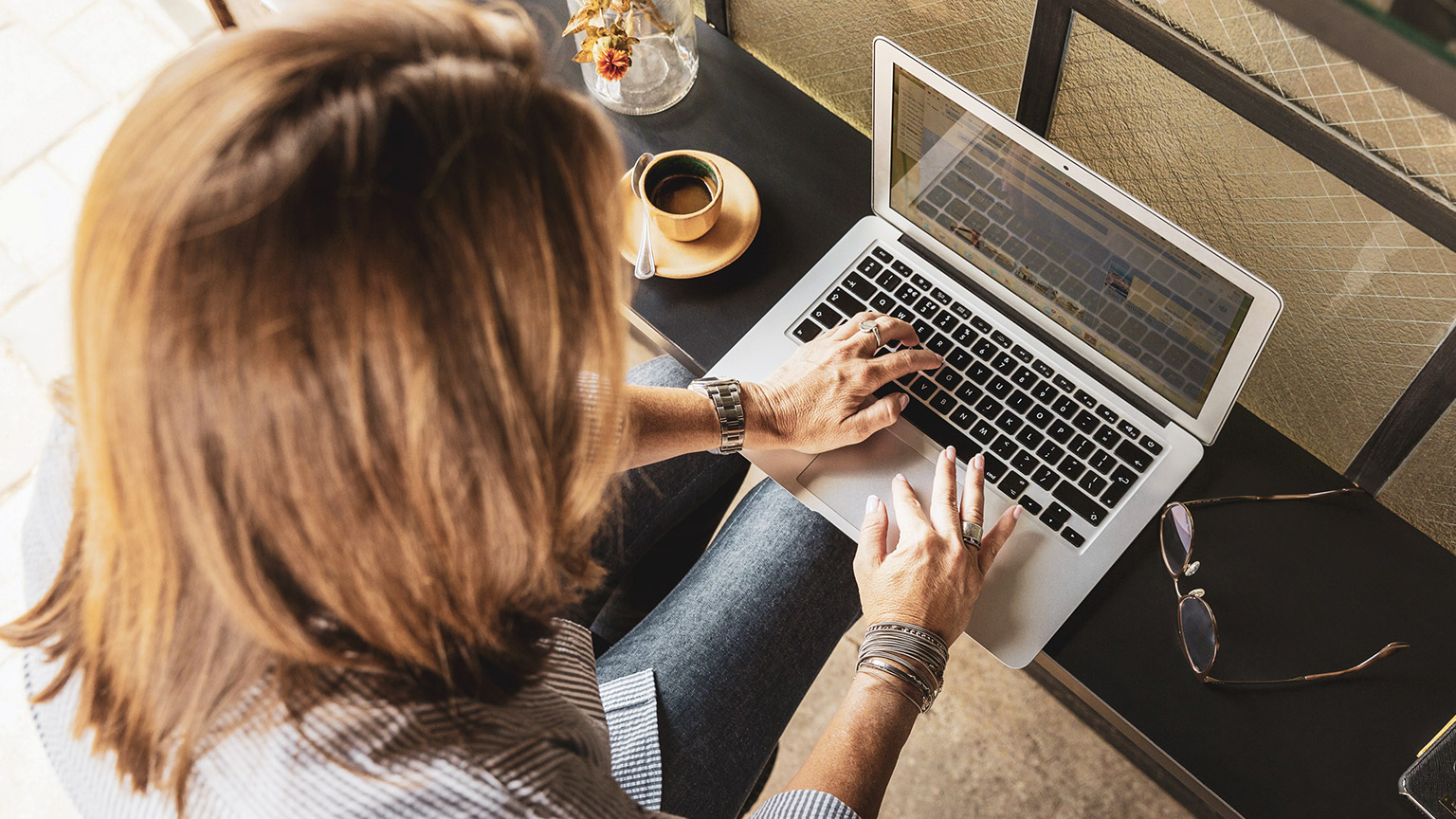 A top down view of a person working on a laptop