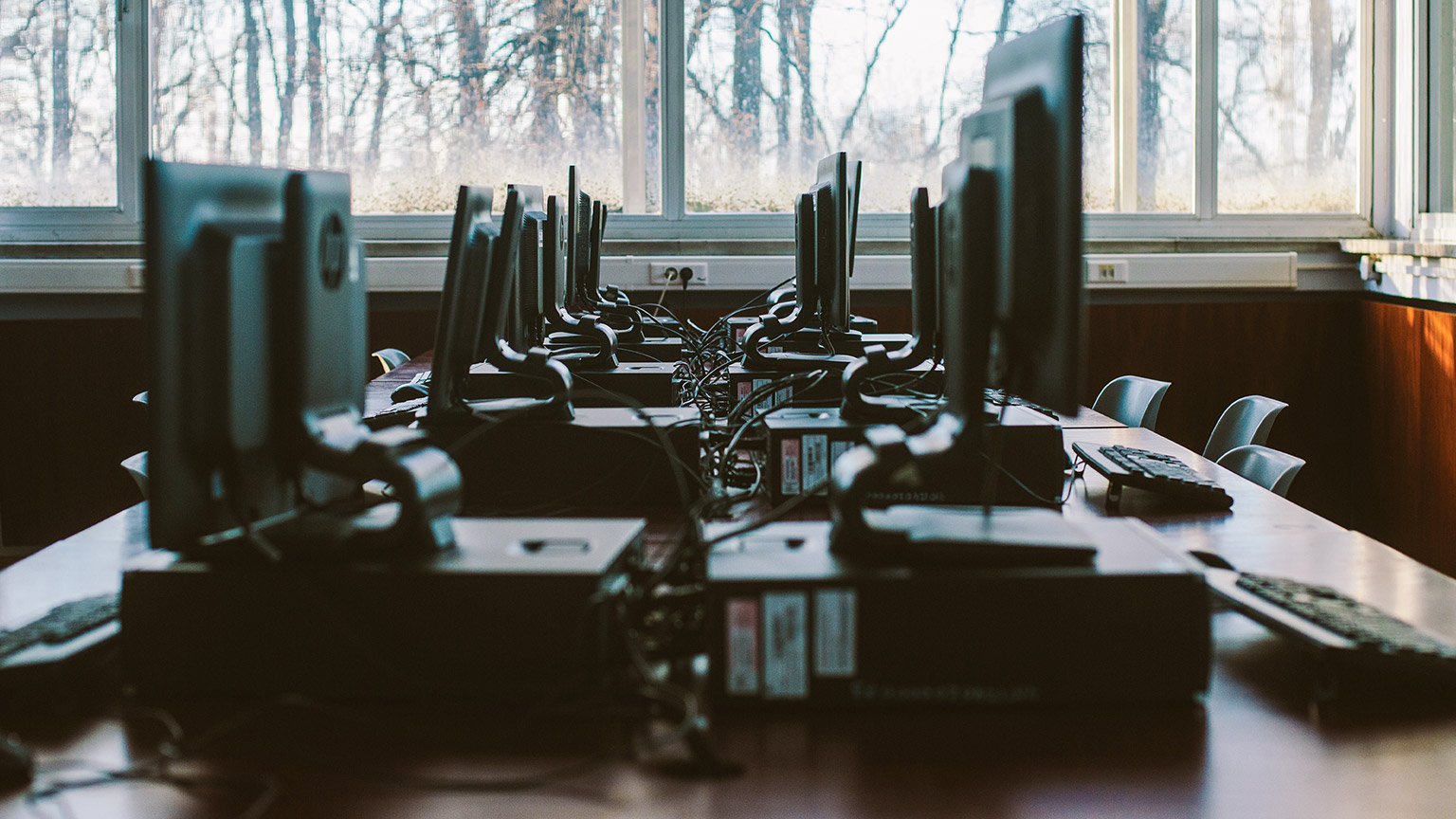 A close view of a network of computers sitting on a long table