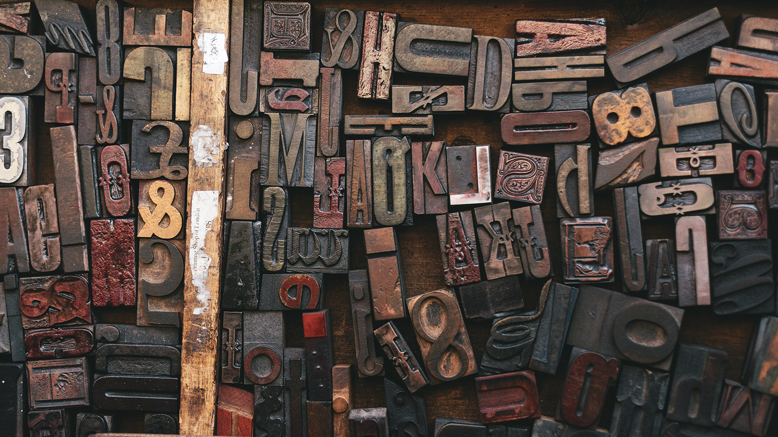 A close view of a box of old metal type