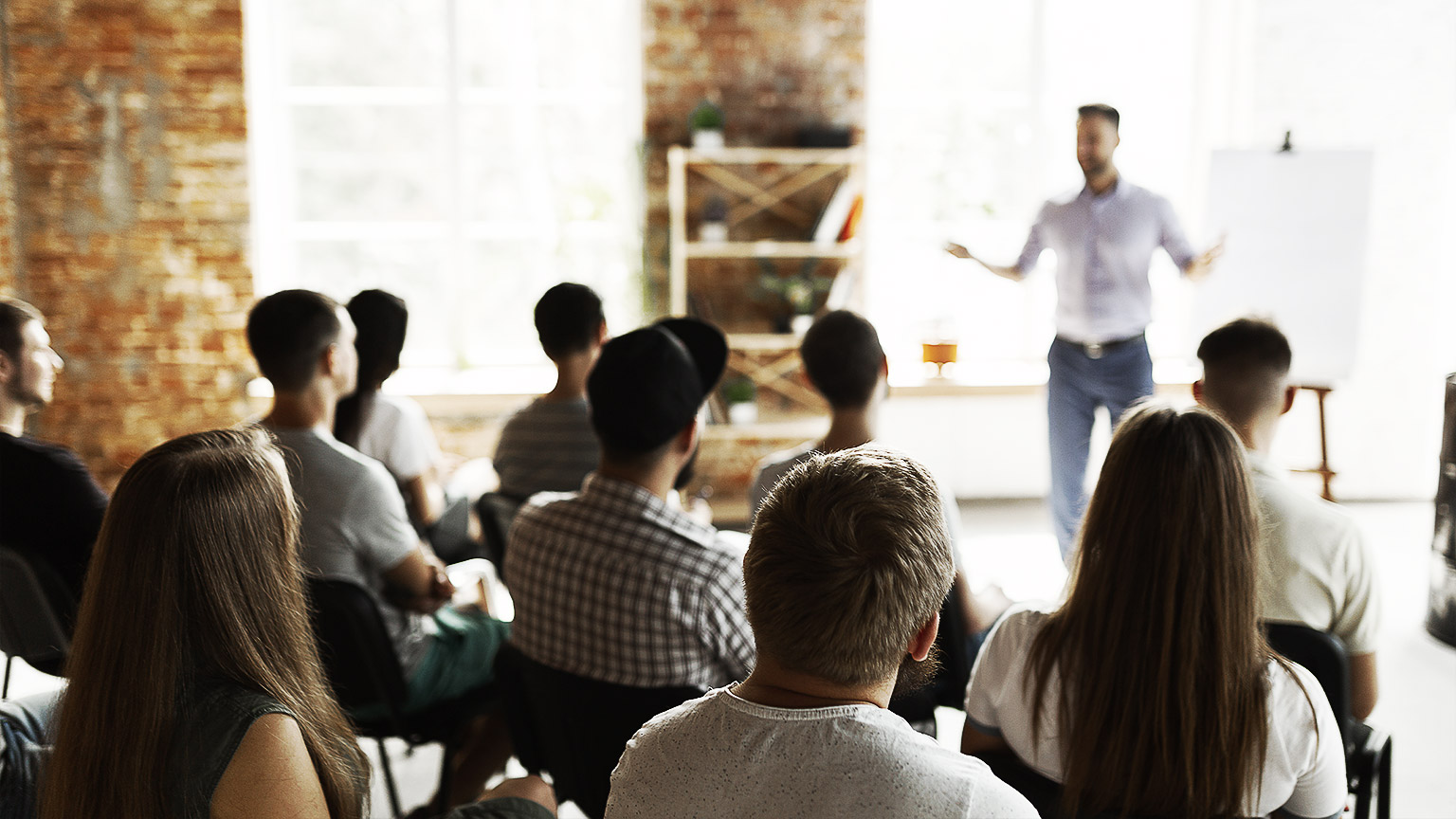 A group of people seated while listening to a workshop