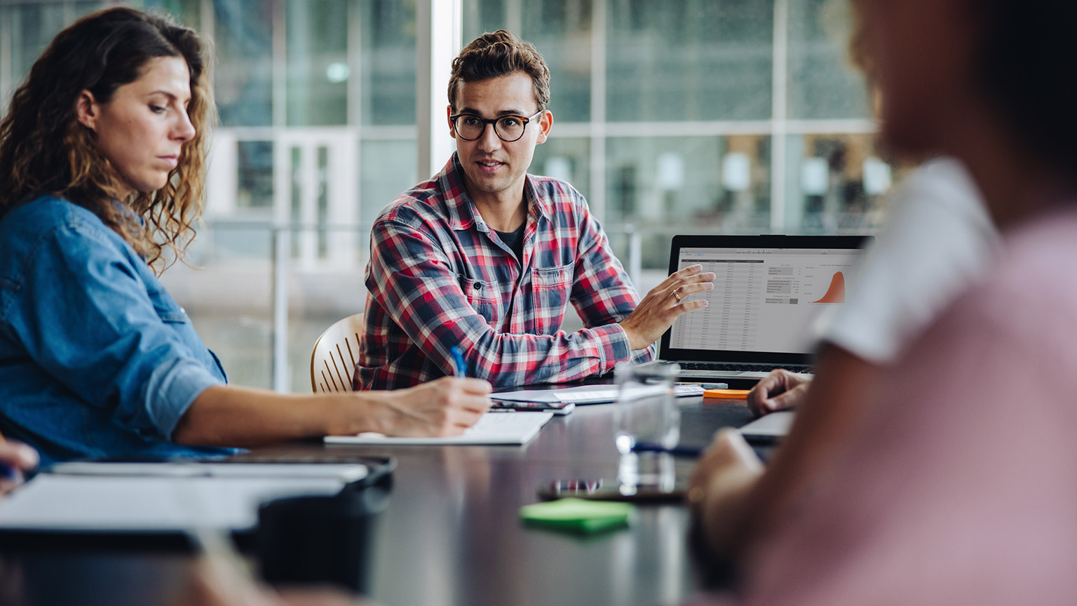 A programmer discussing a project with a team