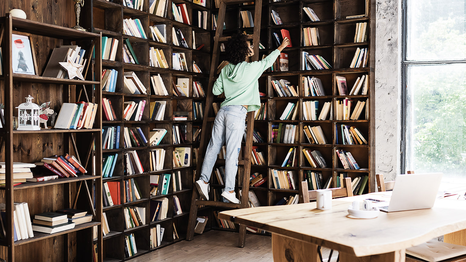 A person reaching for books to read