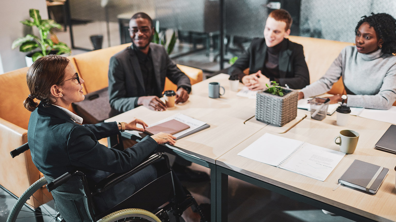 A business group sitting around a table discussing a project