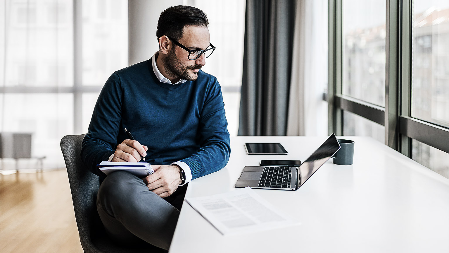 A learning designer working through a laptop