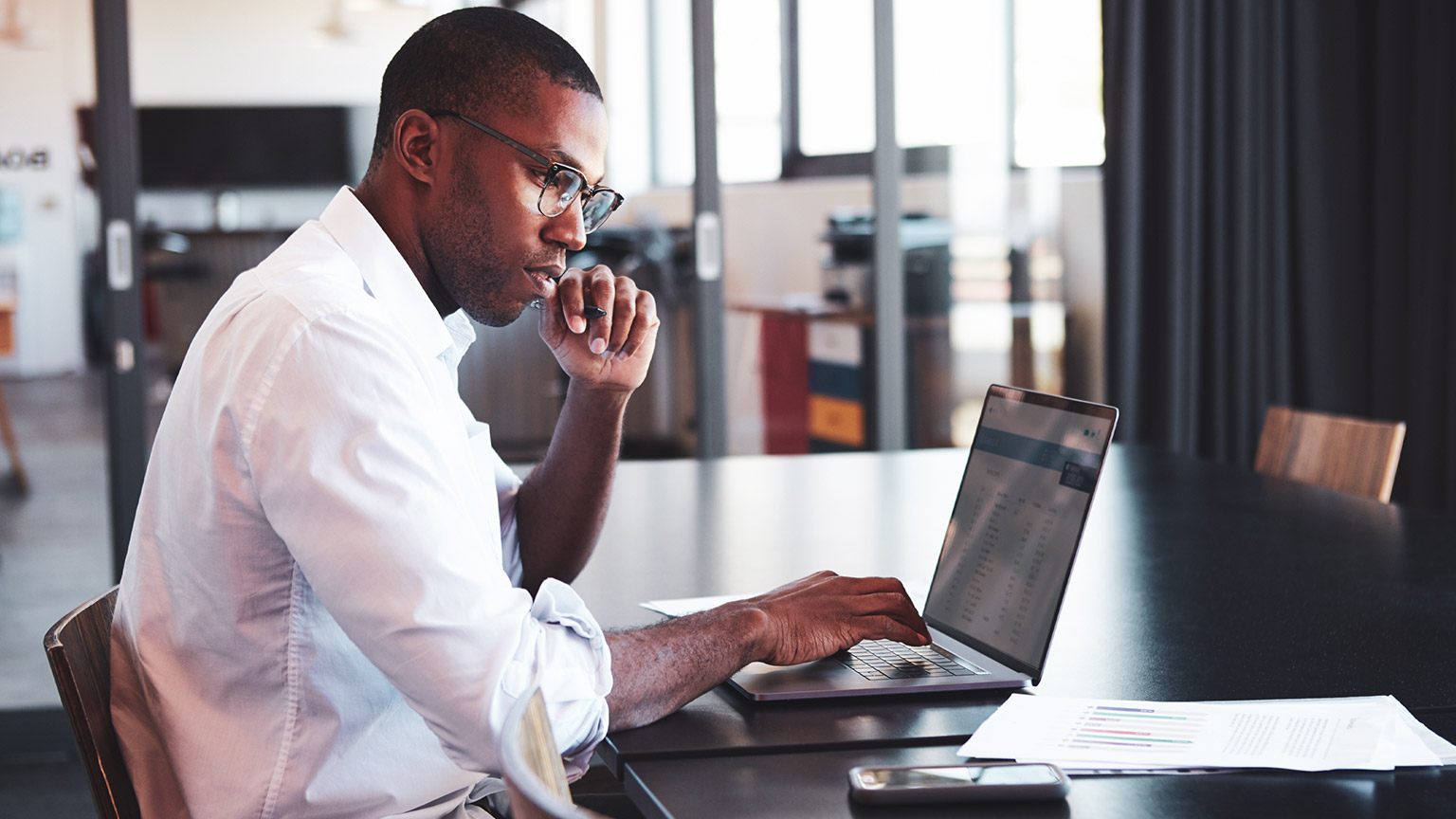 An accountant setting up an online accounting system on a laptop