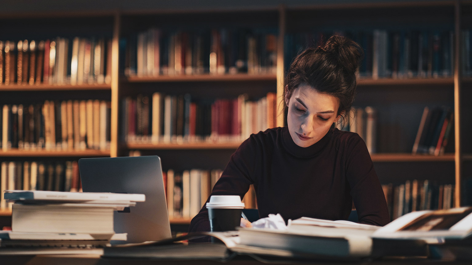 A student working on an assessment in a library