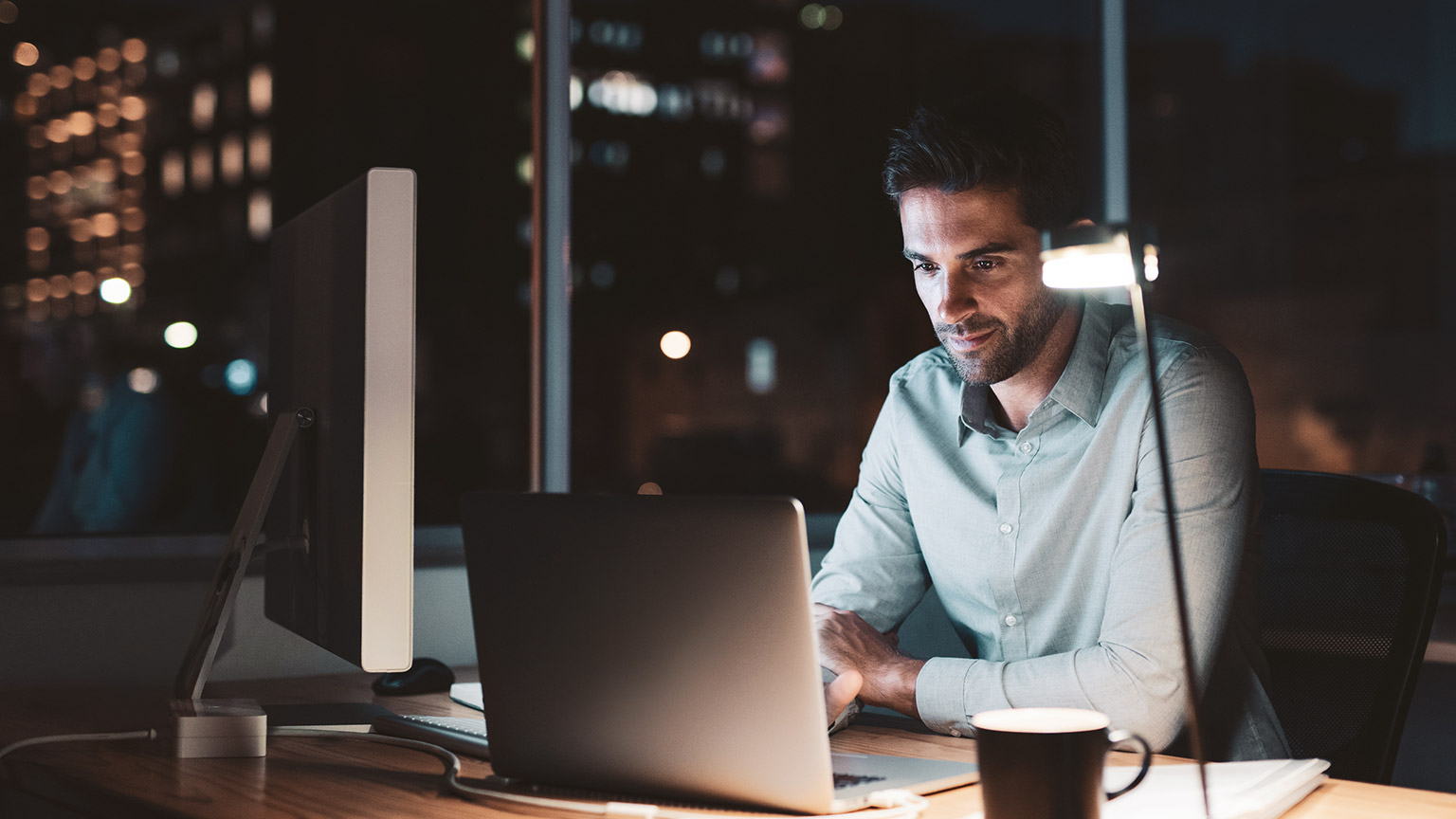 An accountant working on financial jobs on a computer late at night