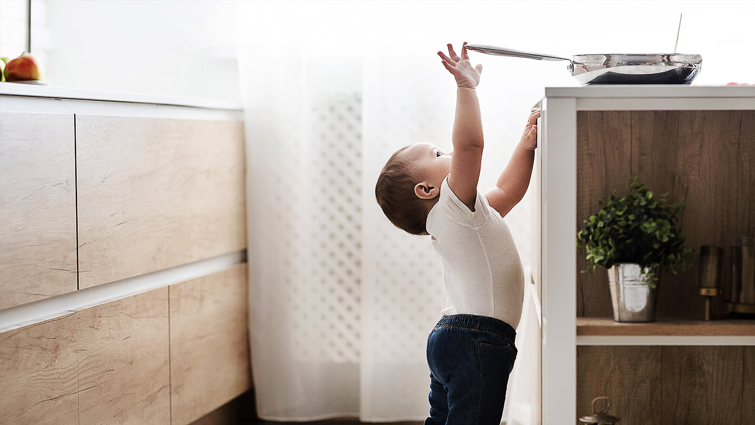 A child reaching for a hot stove