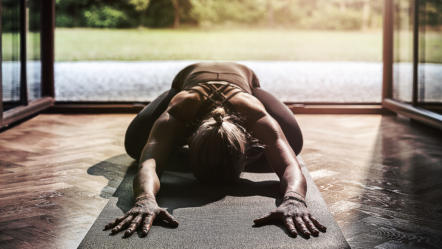 A yogi doing a child's pose on their porch