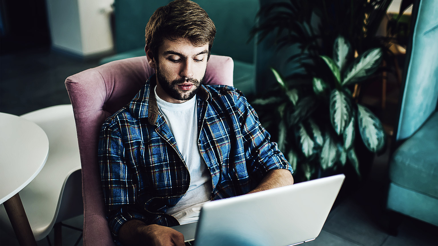 graphic designer working on computer while using graphic tablet at desk in the office