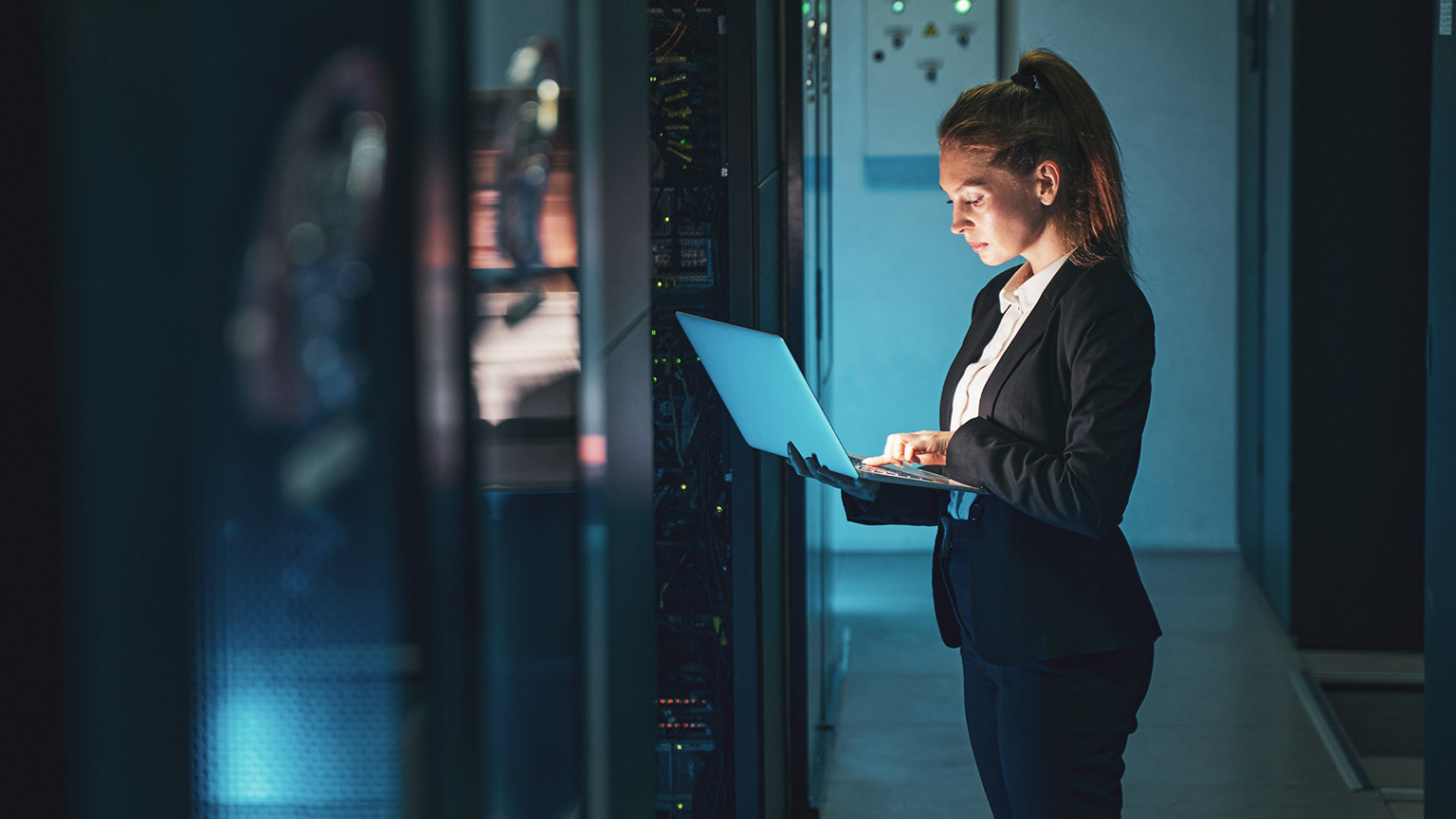 An IT manager checking security protocols on a laptop