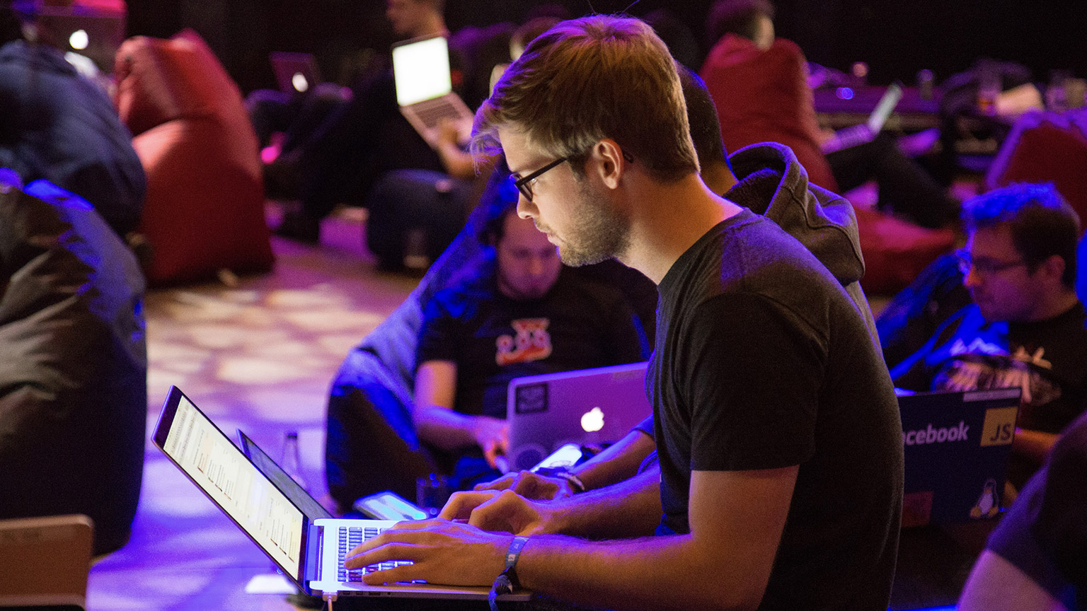 An IT person using a laptop on a wireless network in a relaxed office environment