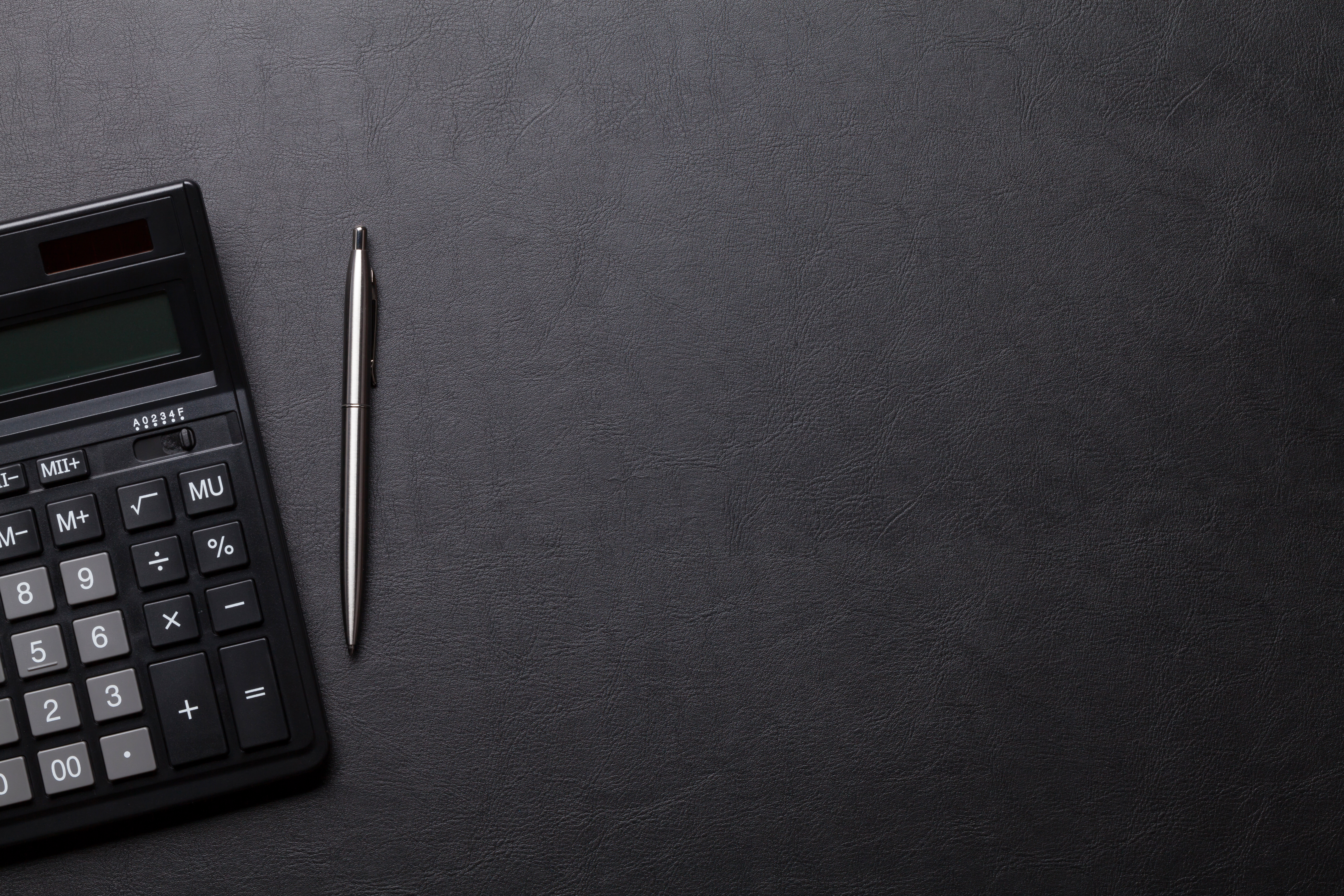 Stock Photo ID: 516570586  Office leather desk table with calculator and pen. Top view with copy space