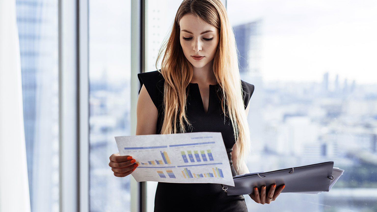 woman holding chart inside office