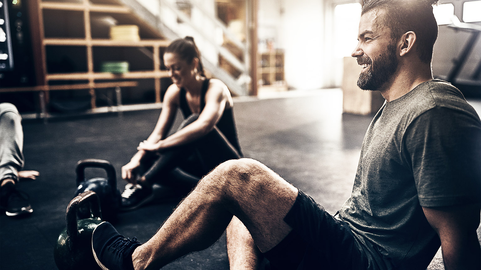 A couple of gym goers happily just finishing their hard workout