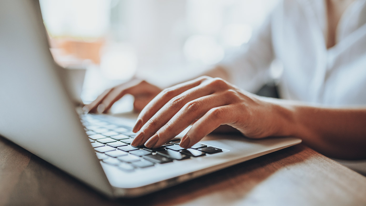 A close view of a person typing on a laptop