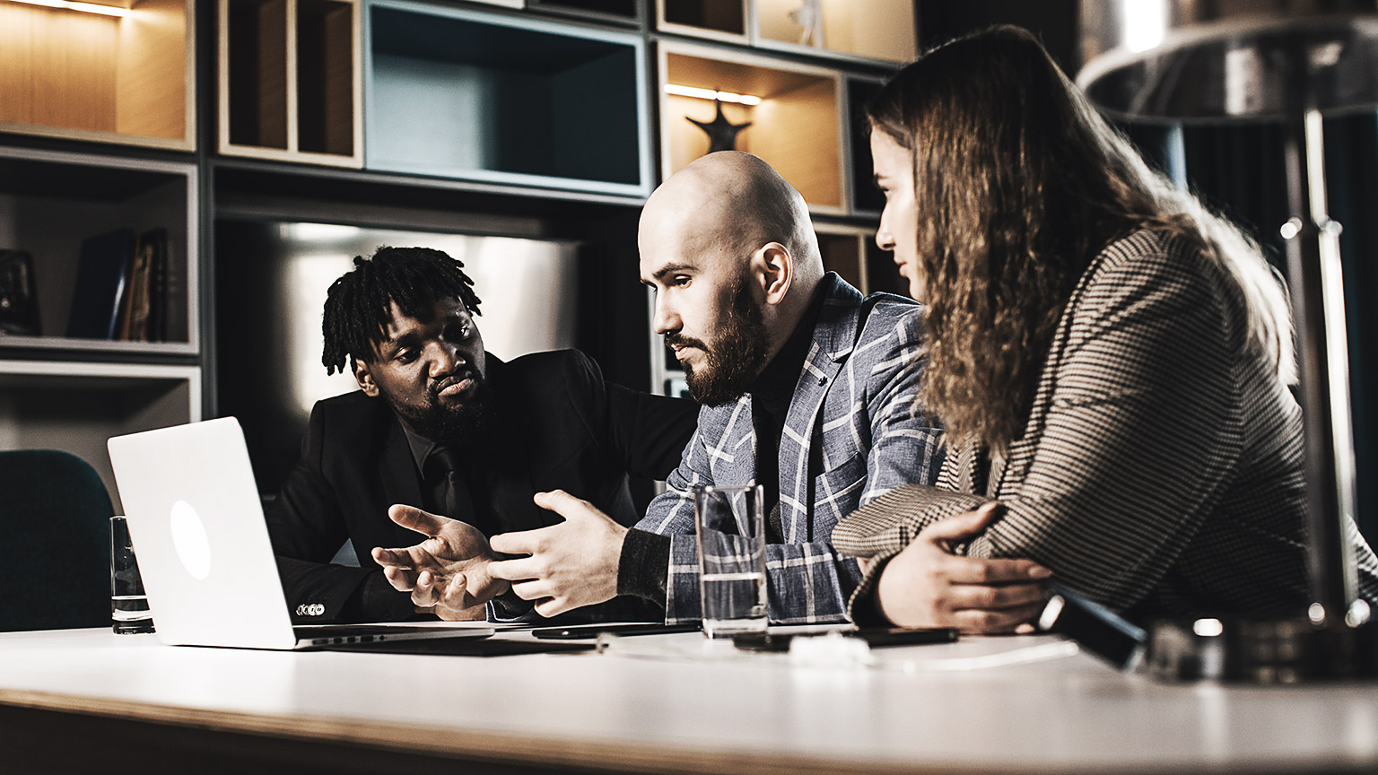 A group of people discussing and monitoring project costs