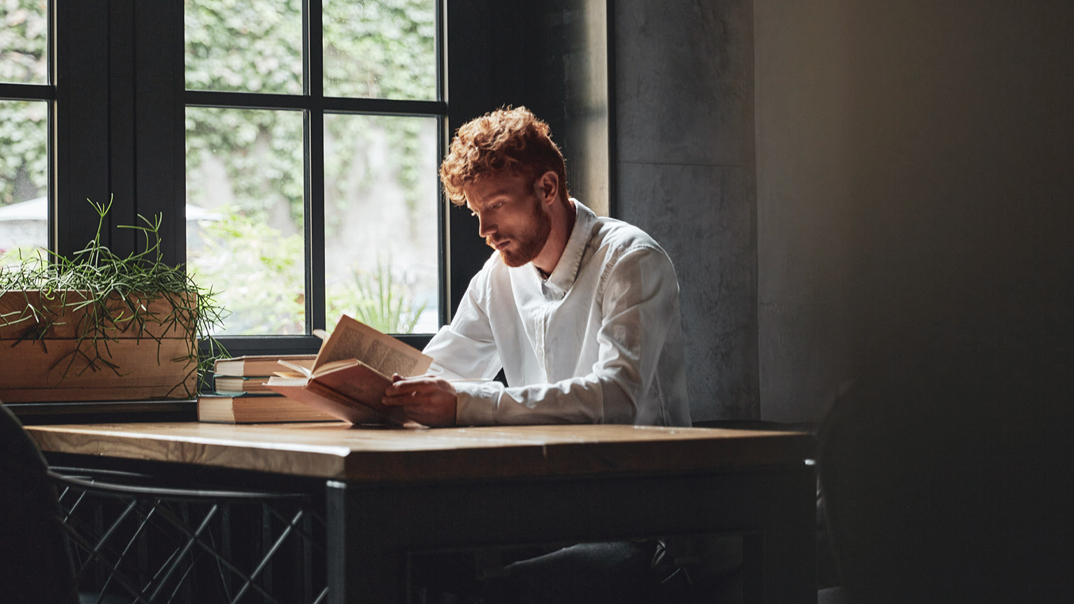 A student reading reference materials in a relaxed environment