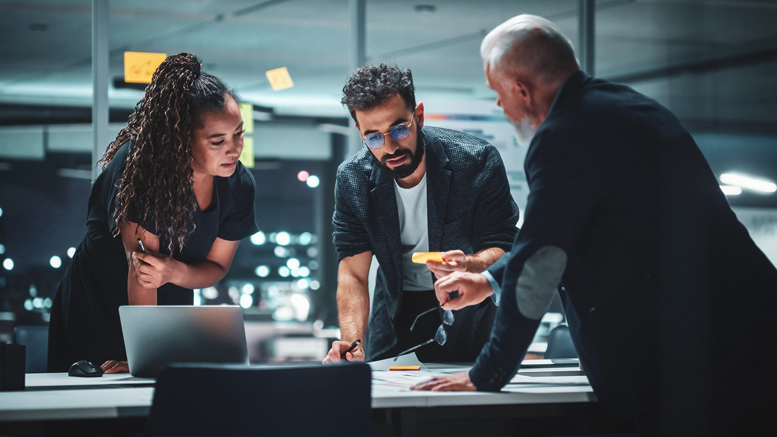 A group of coworkers discussing a project in a meeting room