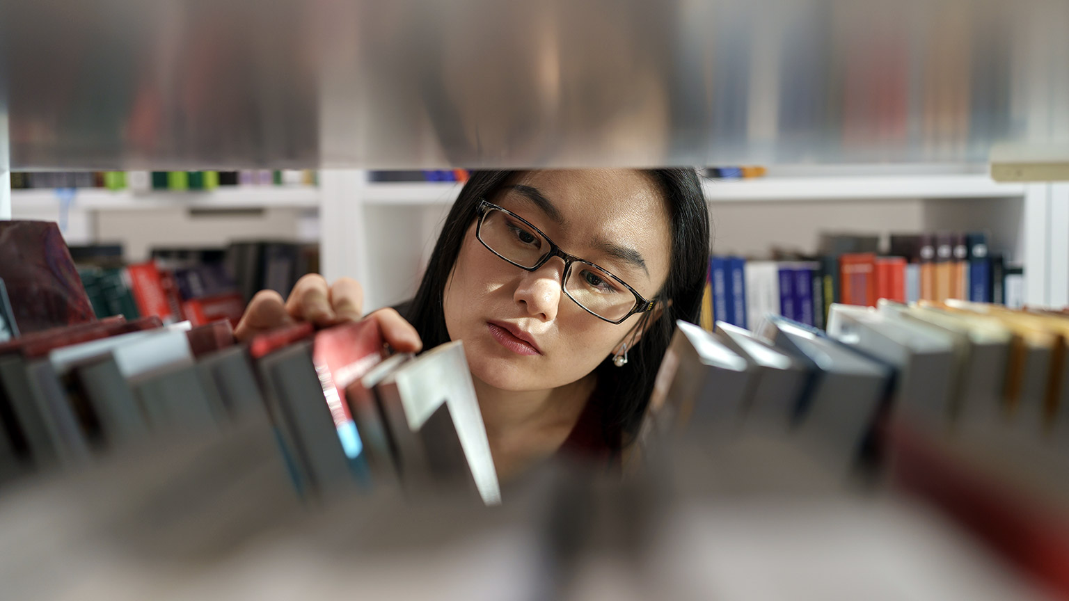 A person browsing books in a library