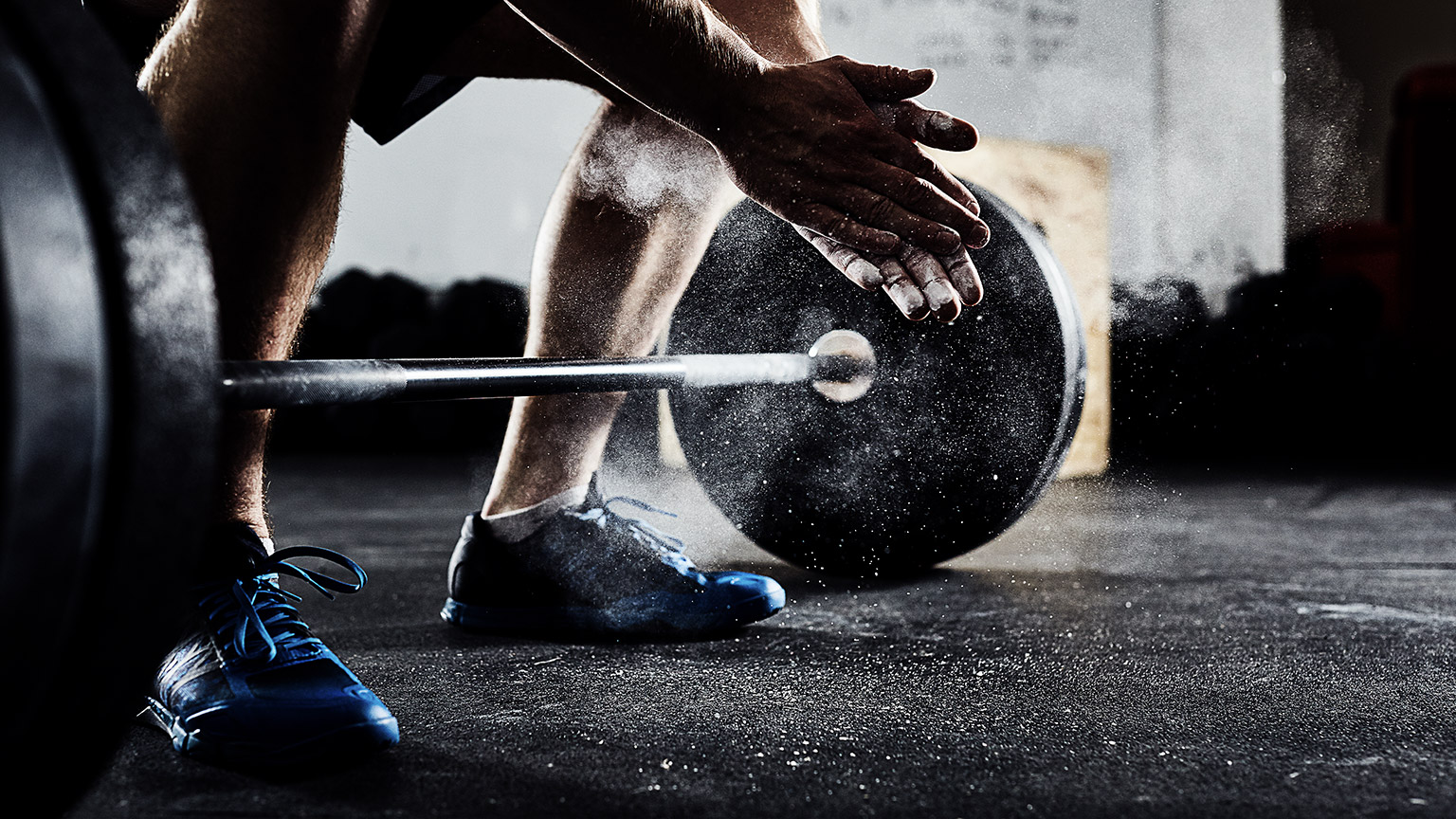 A weight lifter dusting off powder to hype theirselves