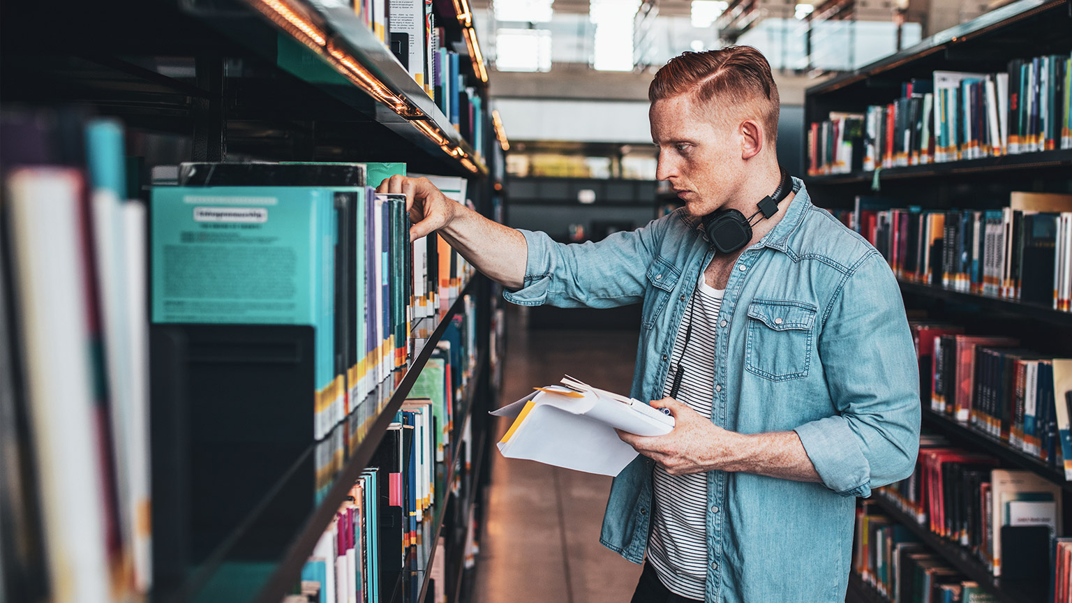 A student looking at reference materials in a library