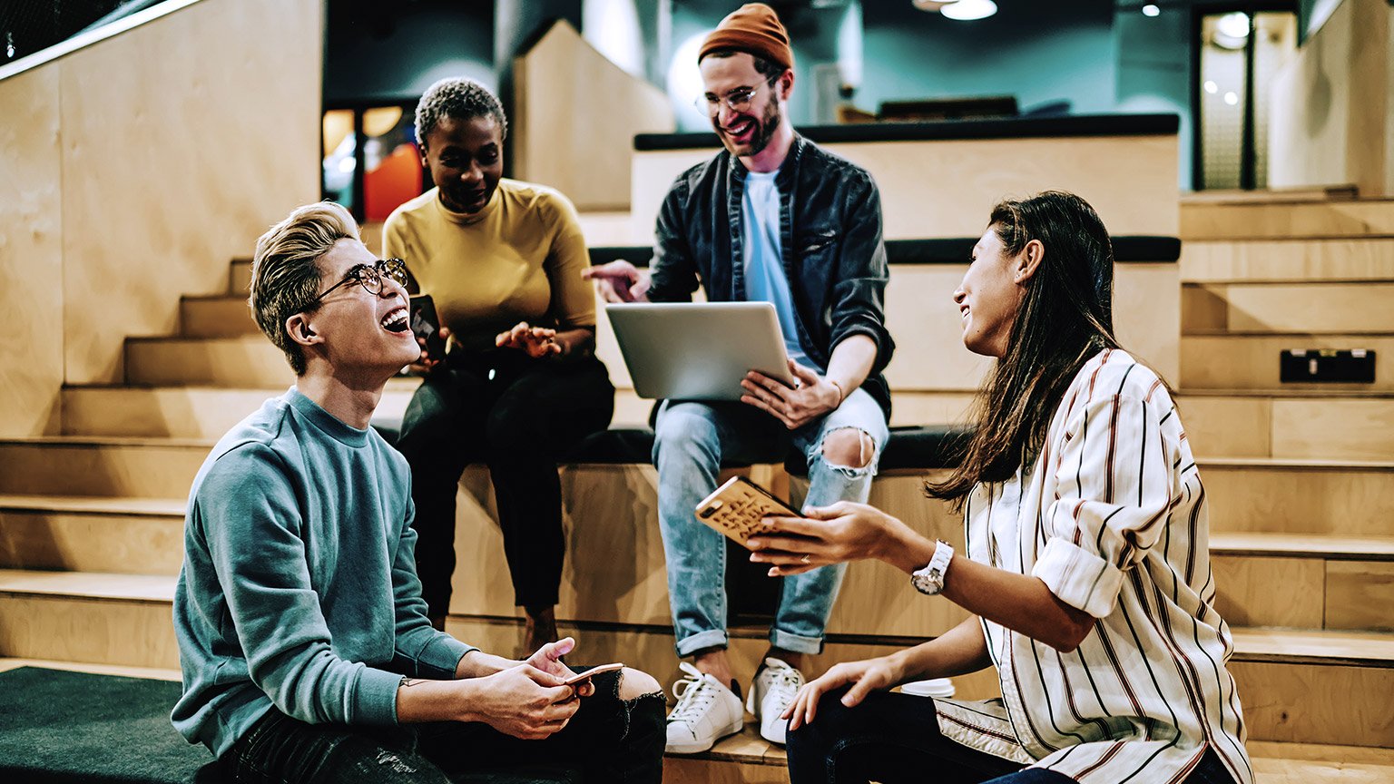 Young hipsters talking with computer and phones