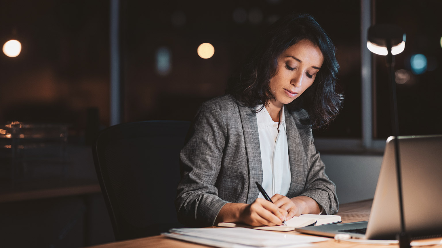 An accountant working on paperwork in the evening