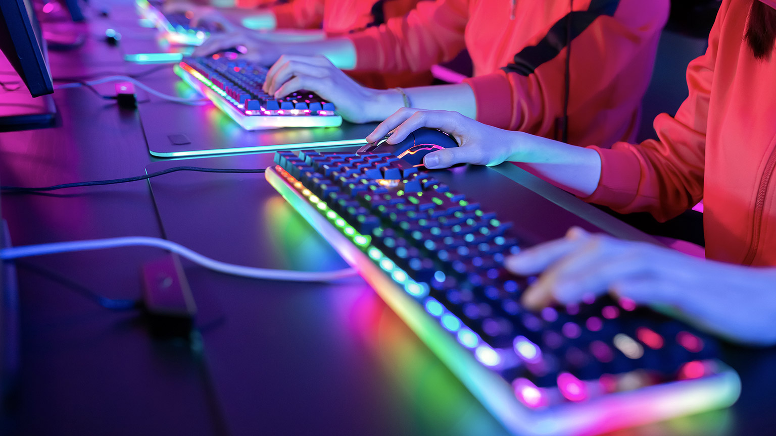 close-up shot of hands on colorful keyboard