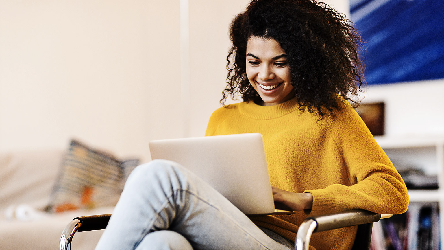 A person happily working on a laptop