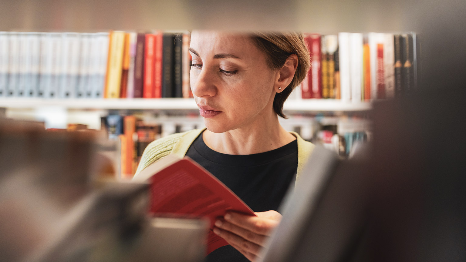 A person in a library reading reference materials