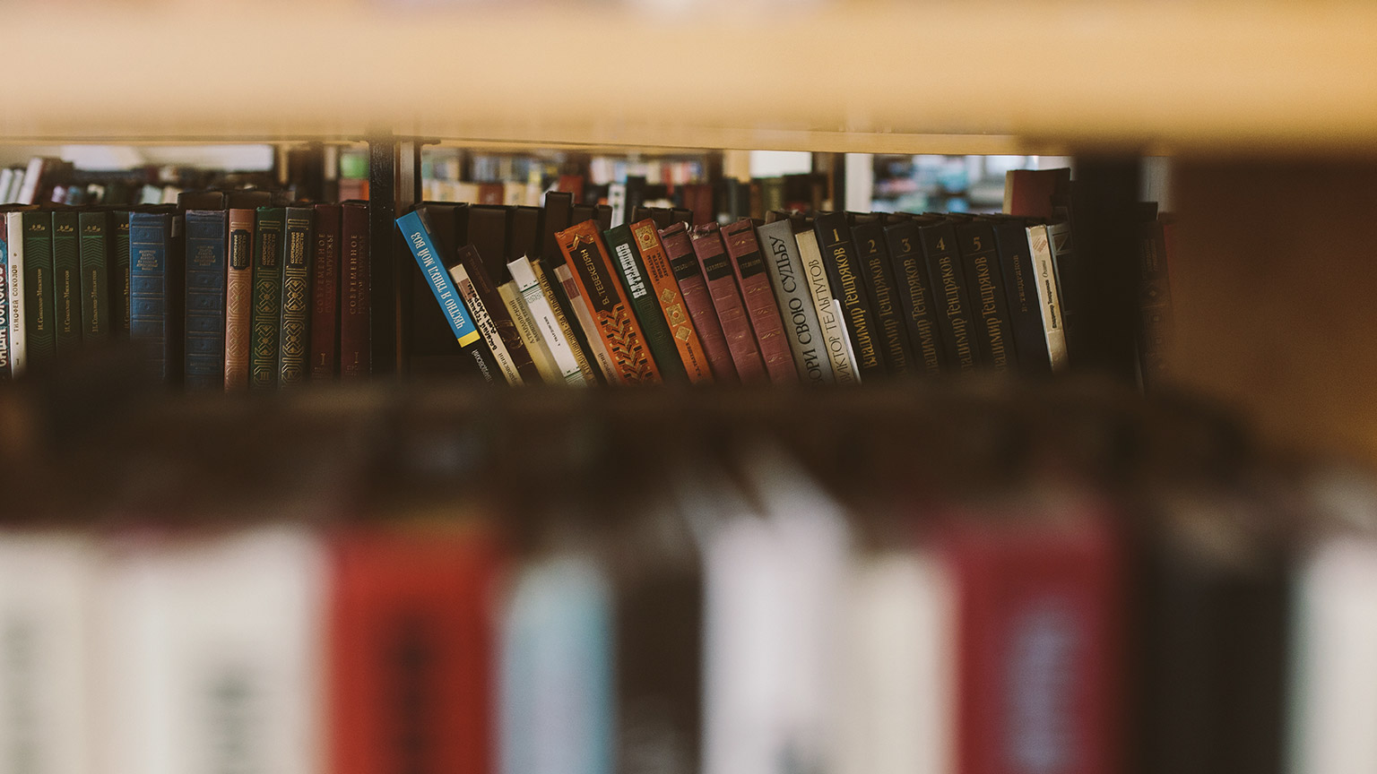 A close view of books on a shelf in a library