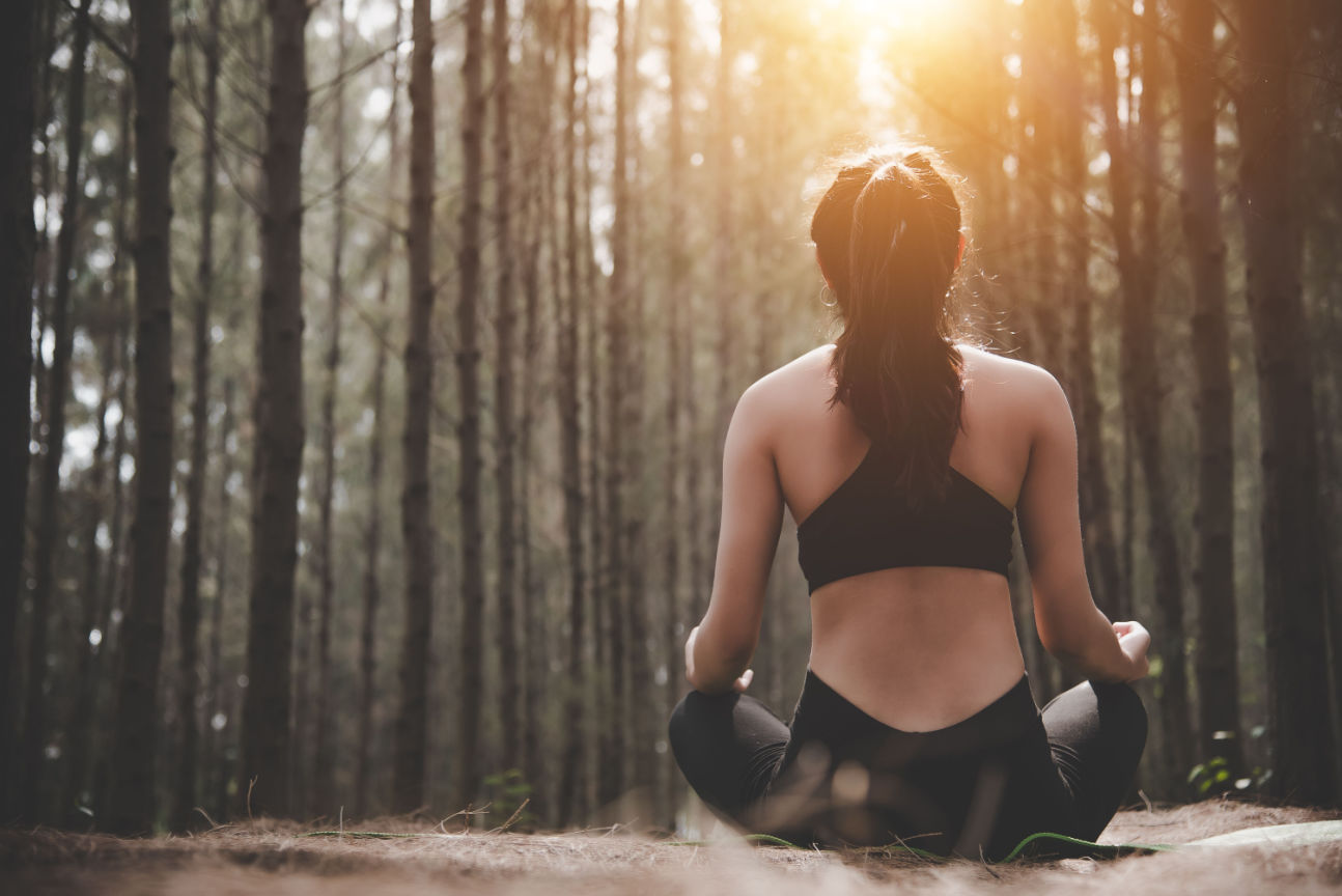 Woman using mindfulness in forest