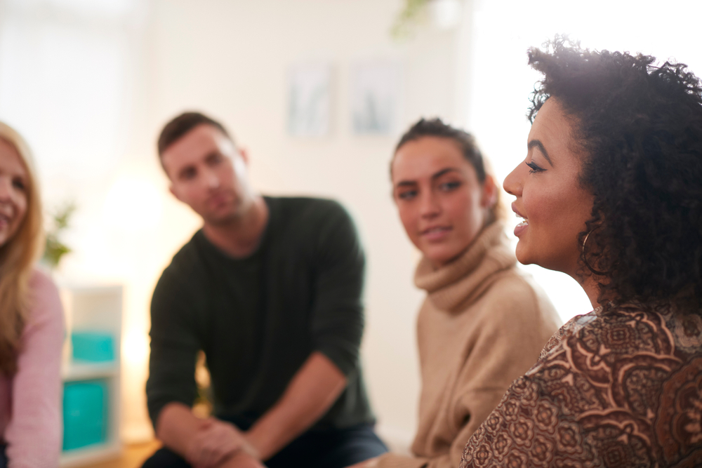 Woman speaking at a group meeting for mental health