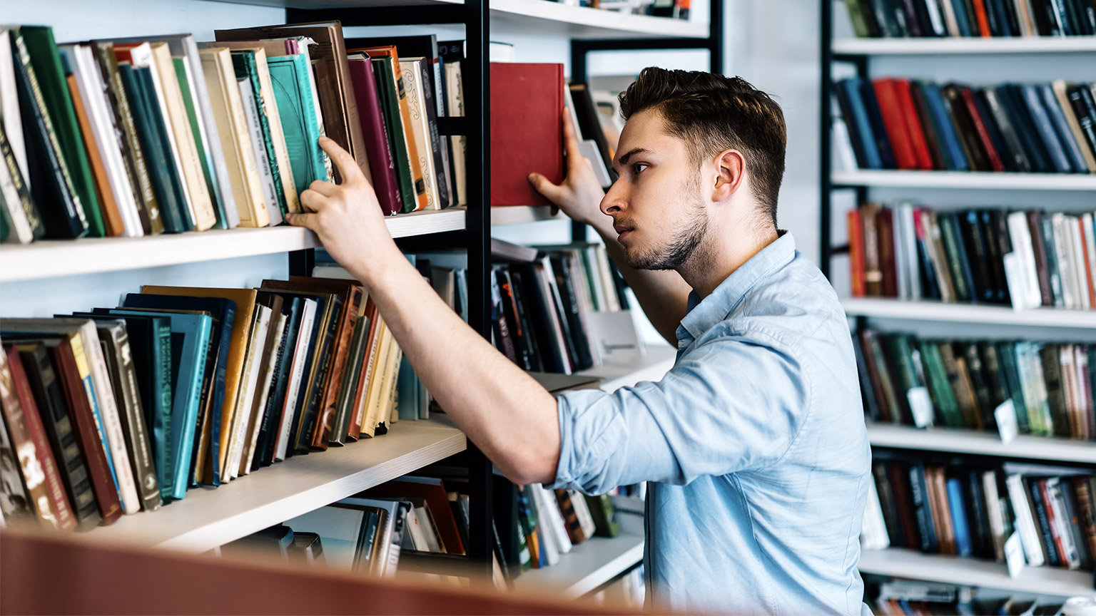 Man selecting books at the library