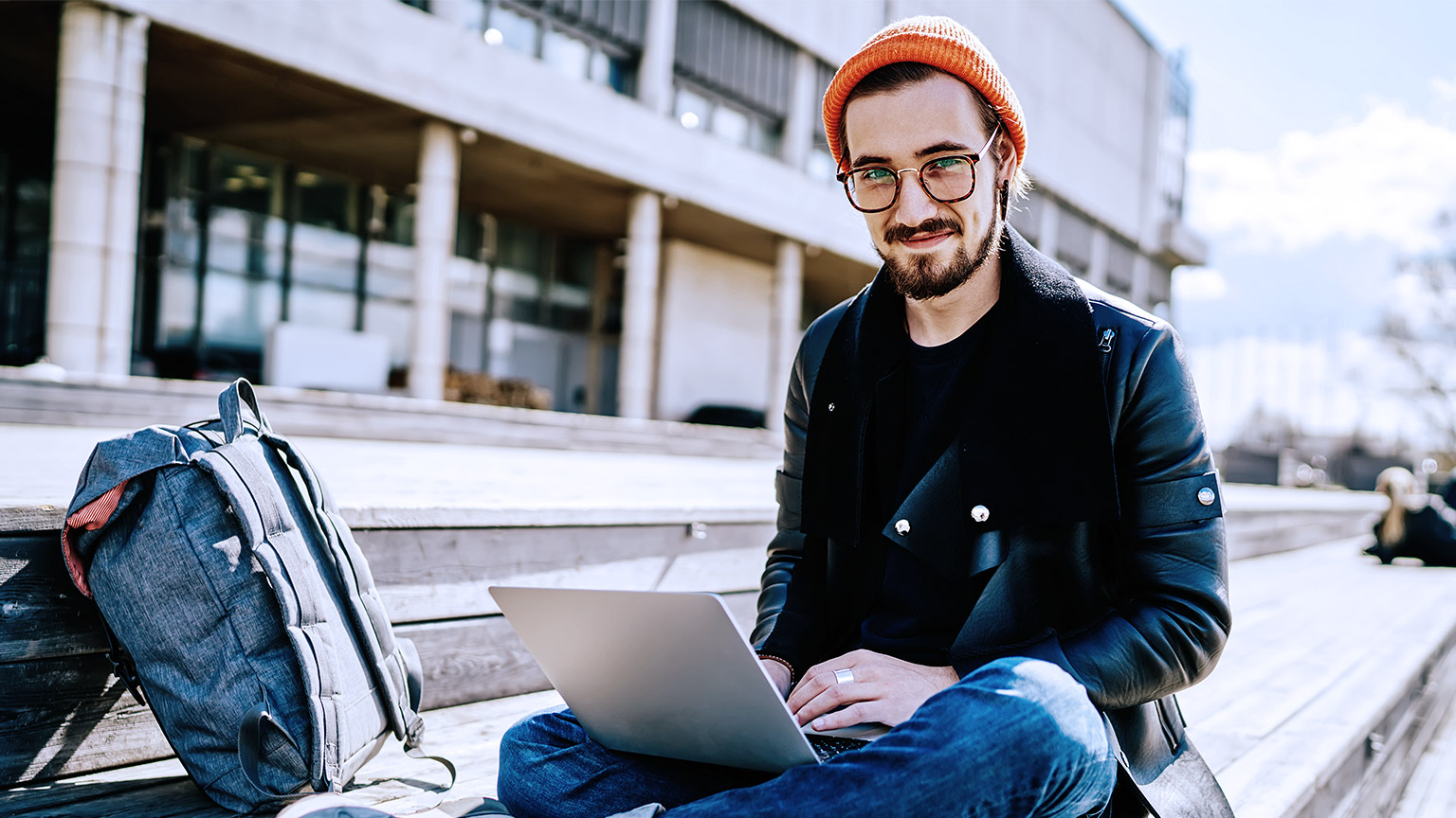 Hipster studying outdoor with laptop