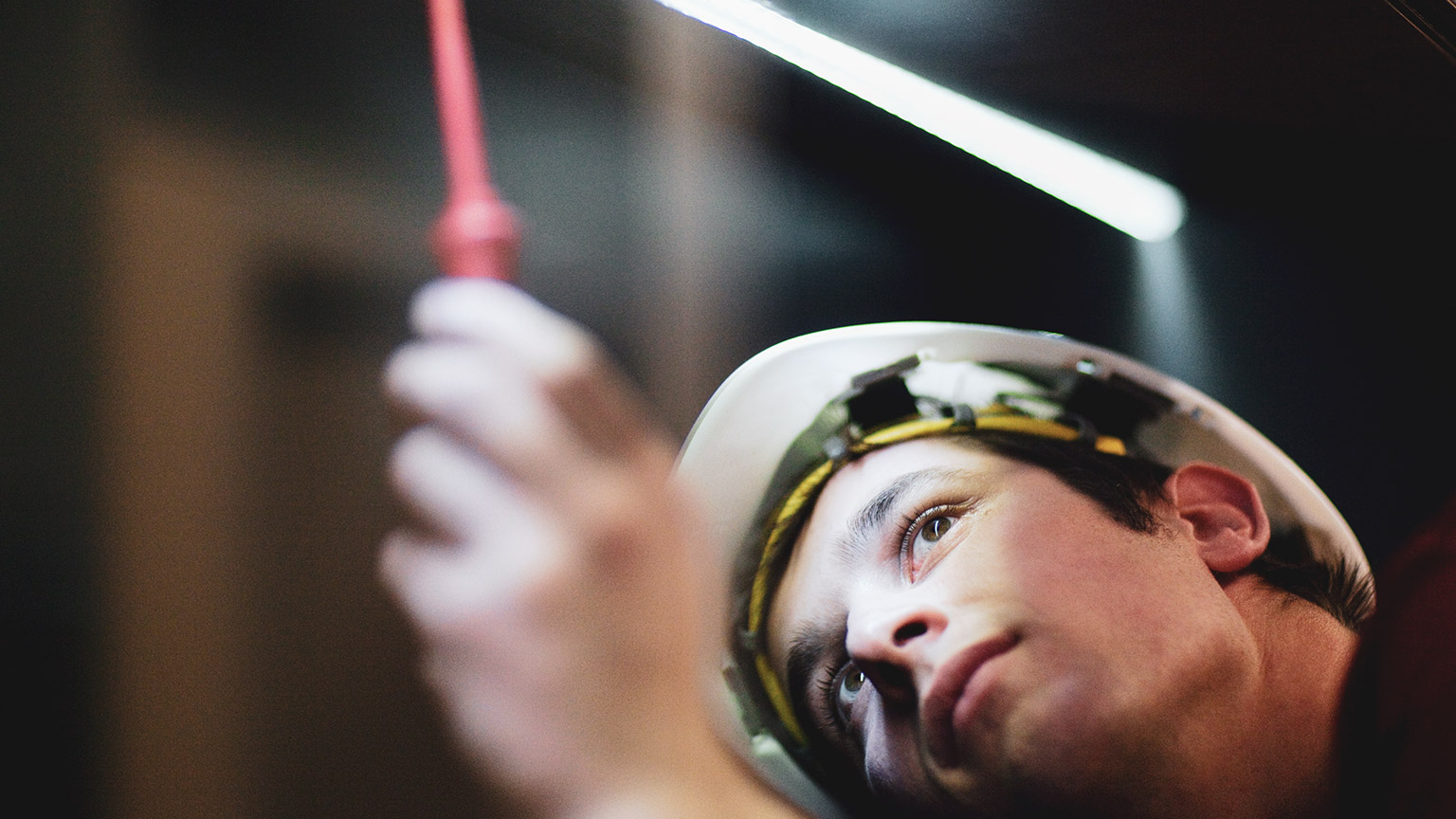 An electrician working in a confined space