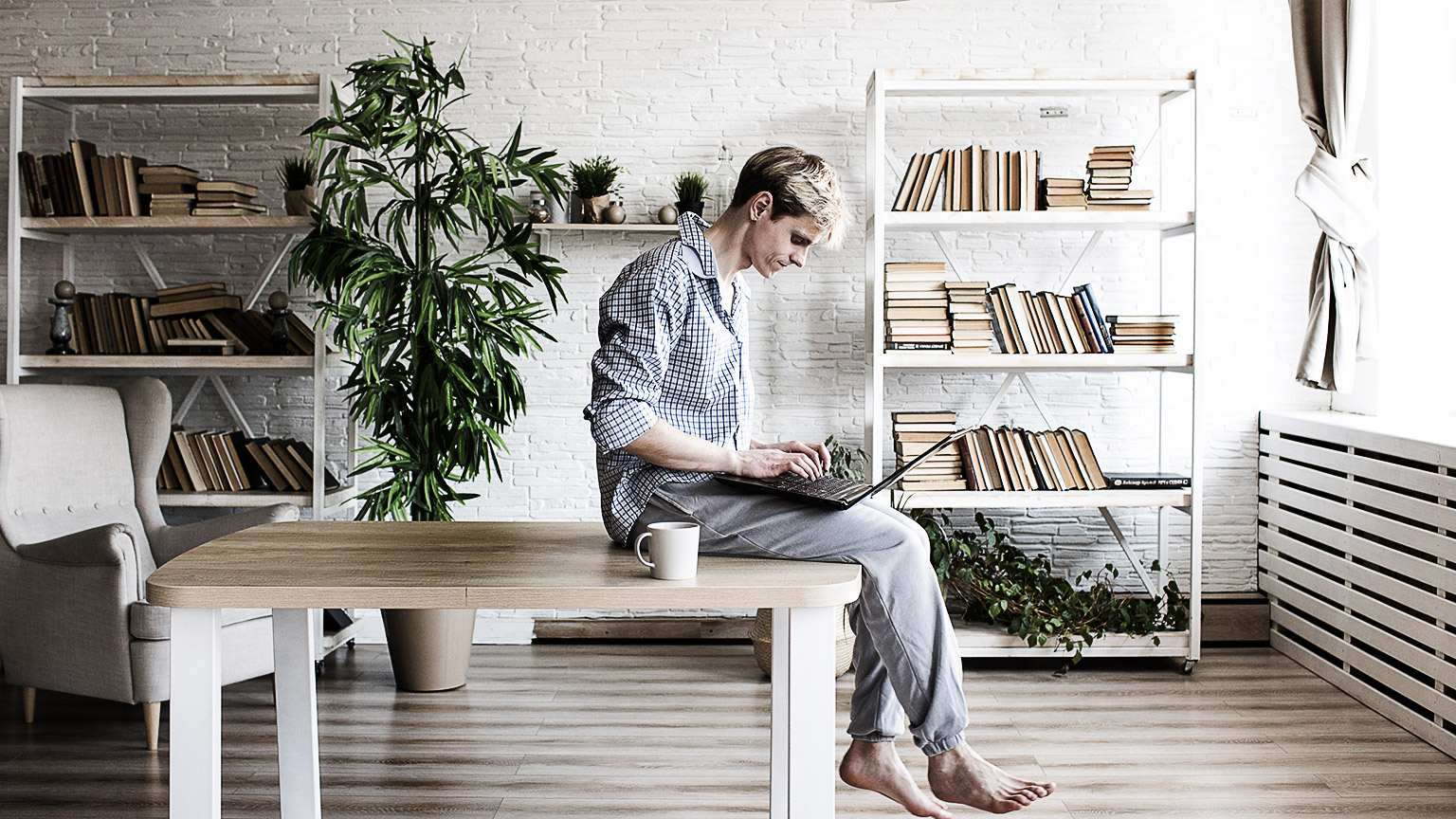 A student on laptop or device in a casual environment