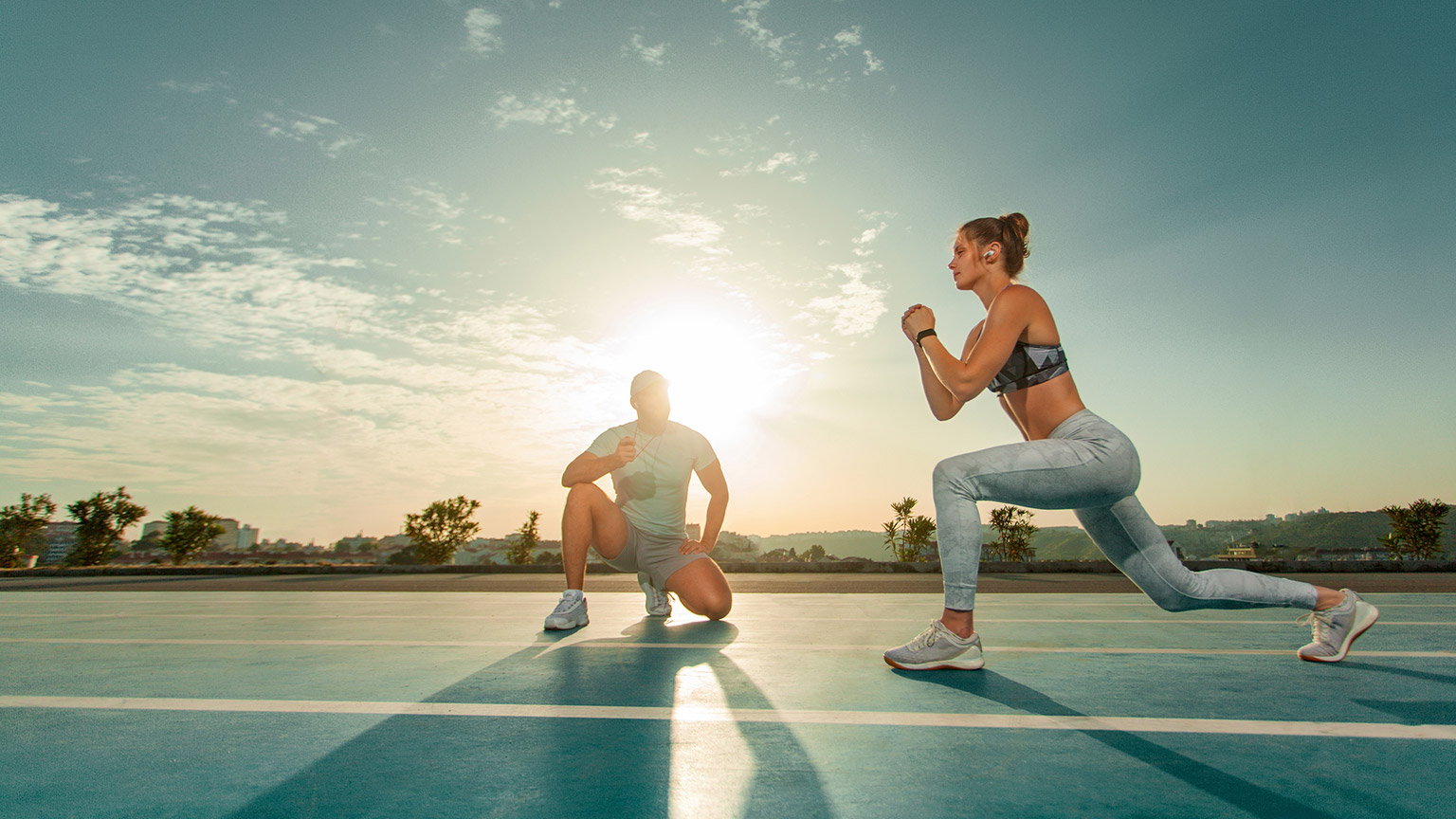 A coach measuring athletic performance in an outdoortrack setting