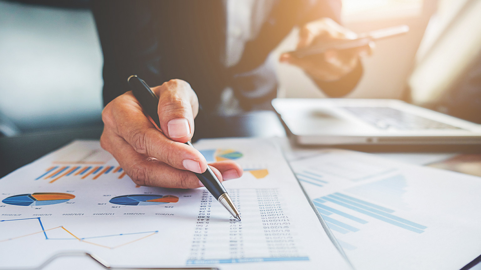 A close view of an accountant checking numbers in a report