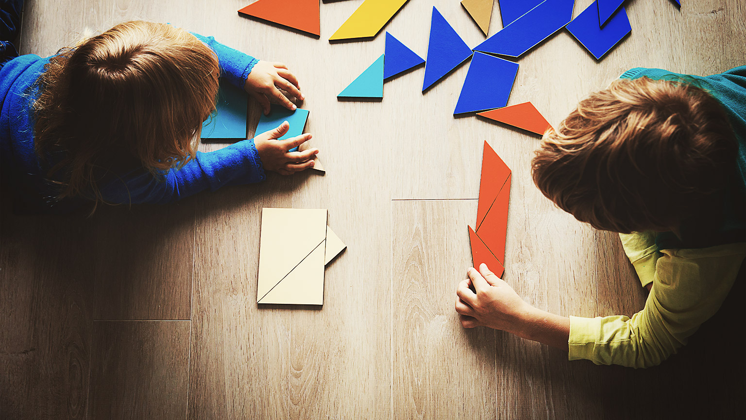 Two kids playing with puzzle blocks