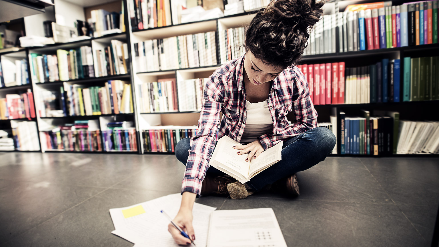 A student researching in a library